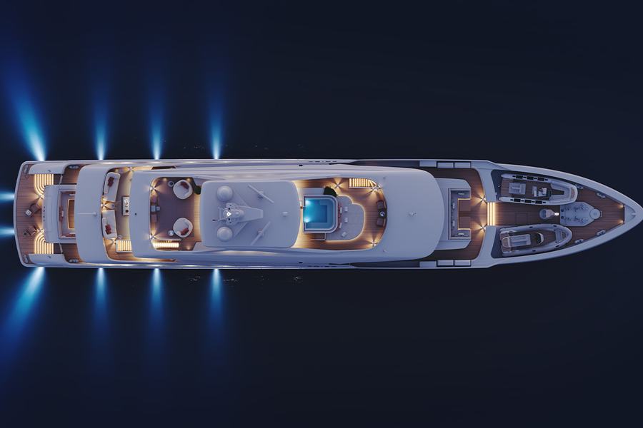 Project Frida - Aerial view of a well-lit yacht at night on dark waters, featuring multiple deck