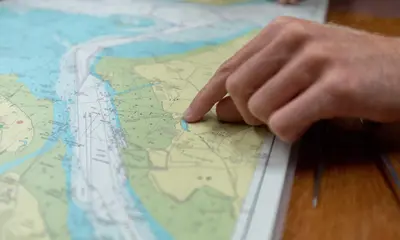 RYA paper-chart consultation — official Royal Yachting Association photograph